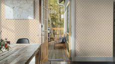 Open door from a hallway with dark hardwood floors, to decking with birch trees in the background