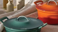 Two Le Creuset dutch ovens, one blue, one orange. 