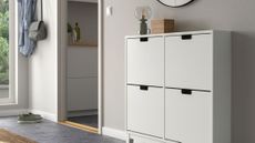White minimalist IKEA shoe storage cabinet styled inside of a light gray entryway area
