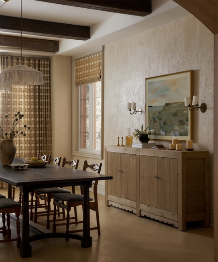 wood dining table with wood cabinet next to wall behind it